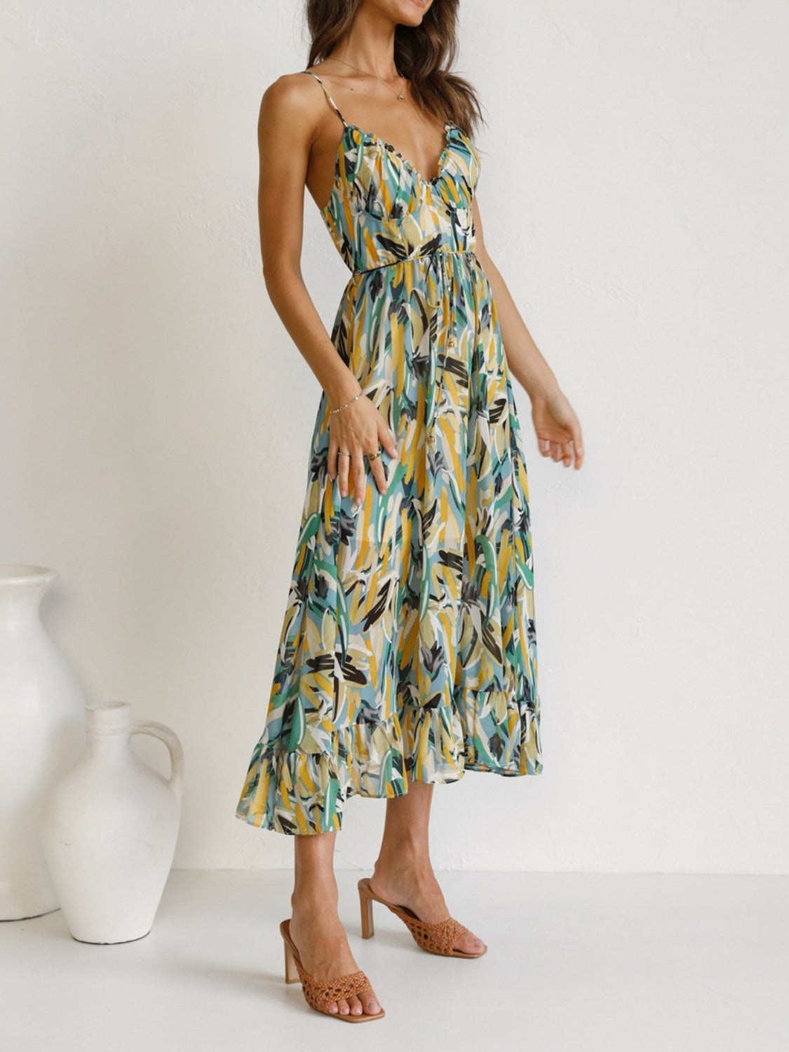 Printed Sleeveless Midi Cami Dress - Front View: Embrace summer romance with a captivating floral print and adjustable spaghetti straps.