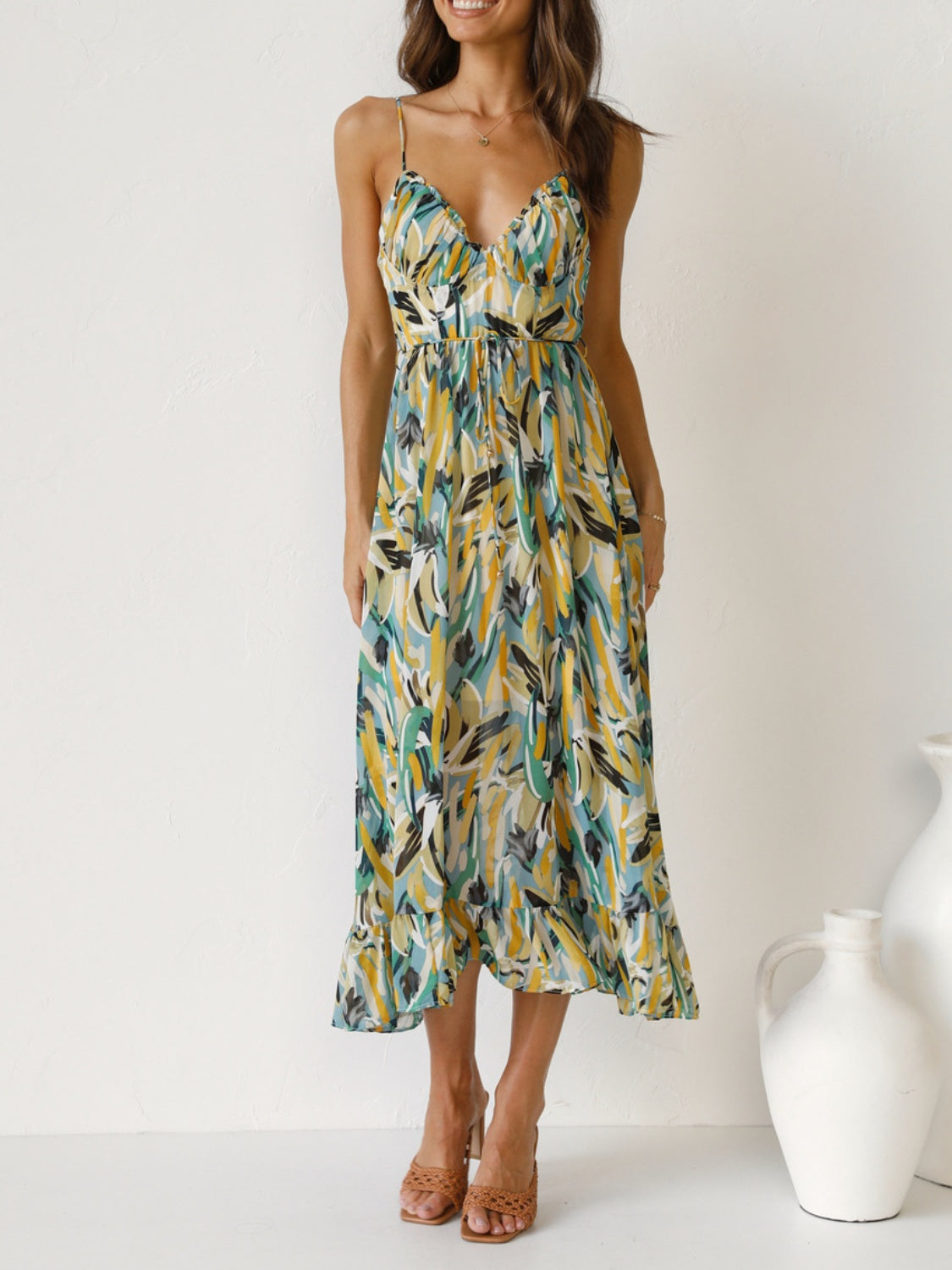 Printed Sleeveless Midi Cami Dress - Front View: Embrace summer romance with a captivating floral print and adjustable spaghetti straps.