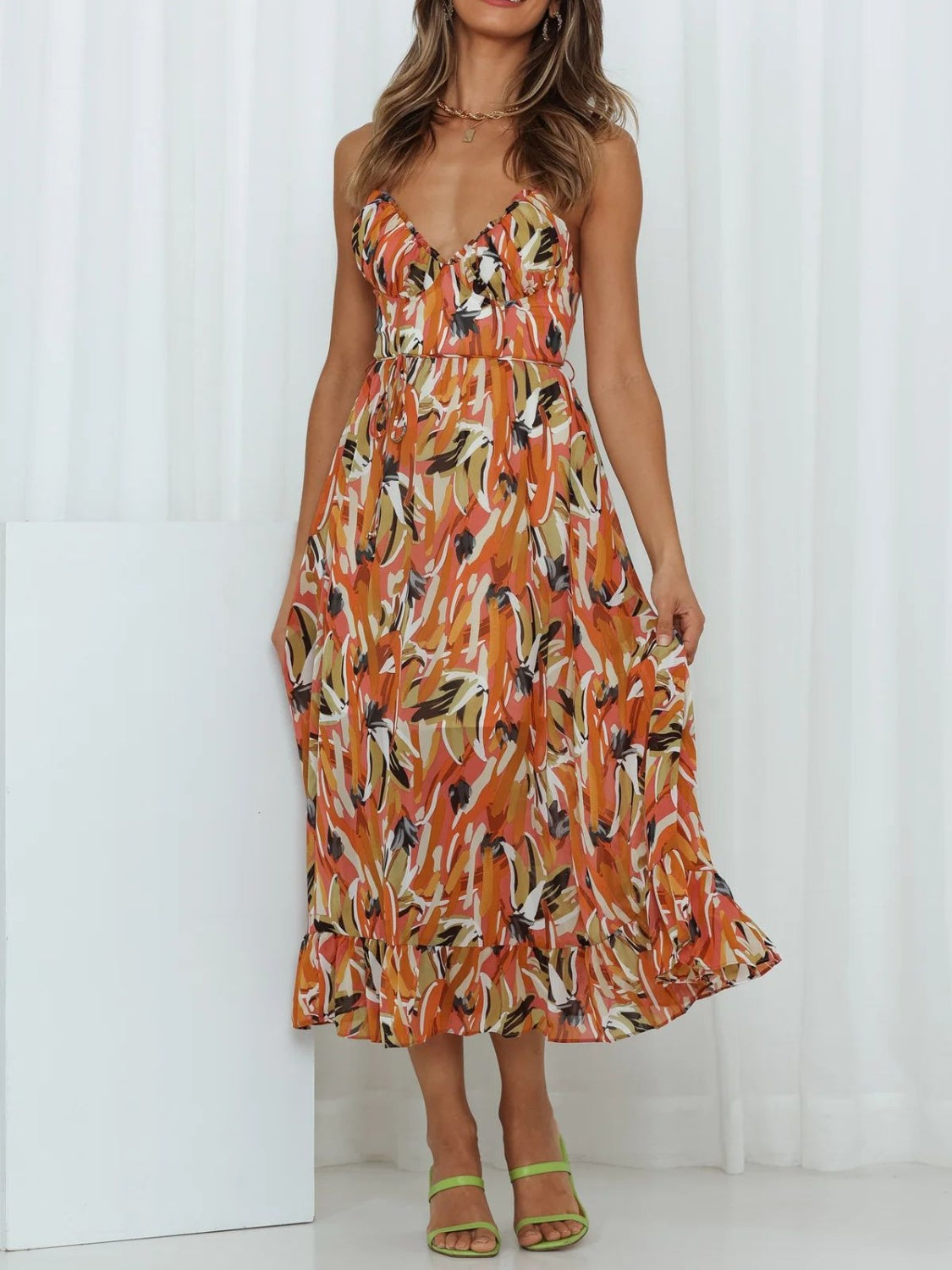 Printed Sleeveless Midi Cami Dress - Front View: Embrace summer romance with a captivating floral print and adjustable spaghetti straps.